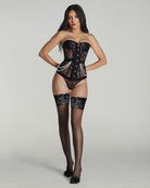 Woman wearing a black lace lingerie set on a gray background